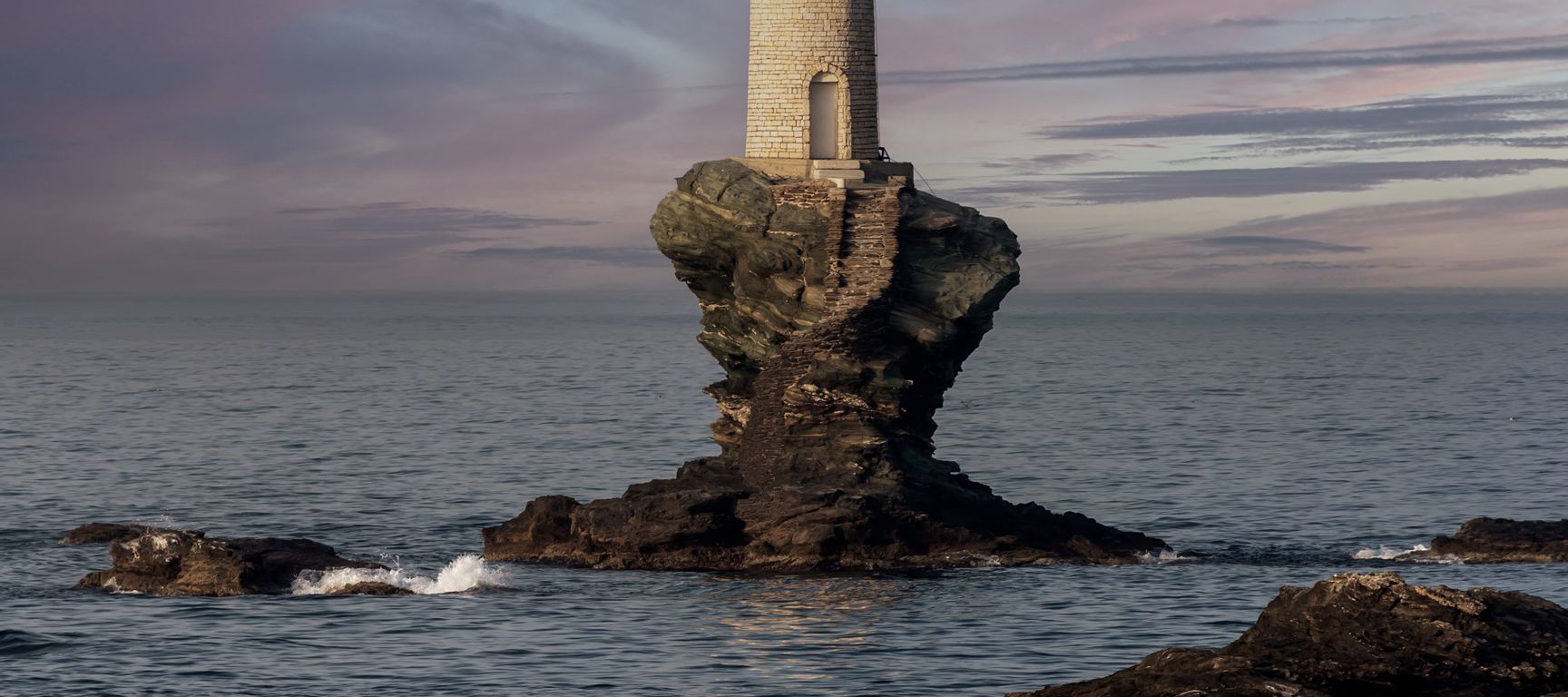 Der Tourlitis-Leuchtturm auf einem Felsen vor der Stadt Andros Chora