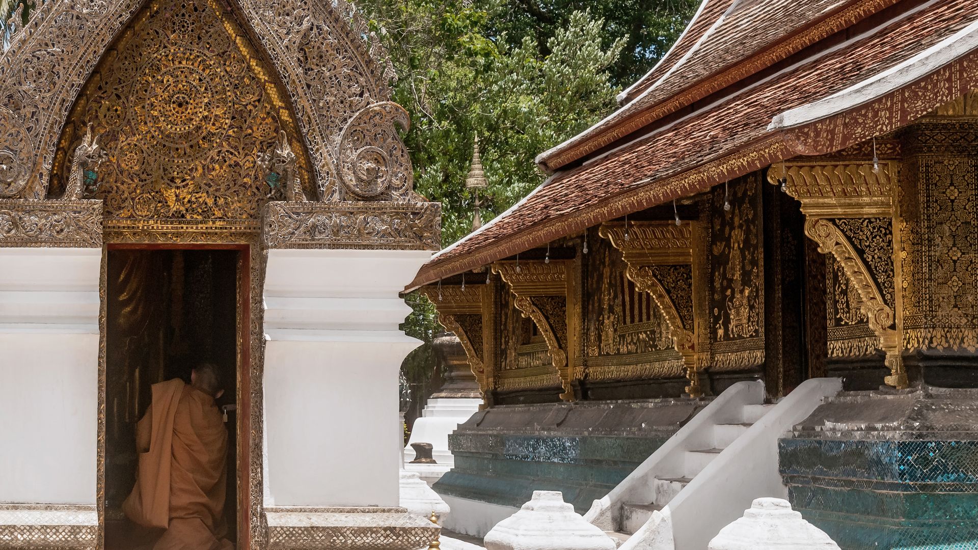Ein buddhistischer Mönch beim Gebet im Xieng-Thong-Tempel in Luang Prabang
