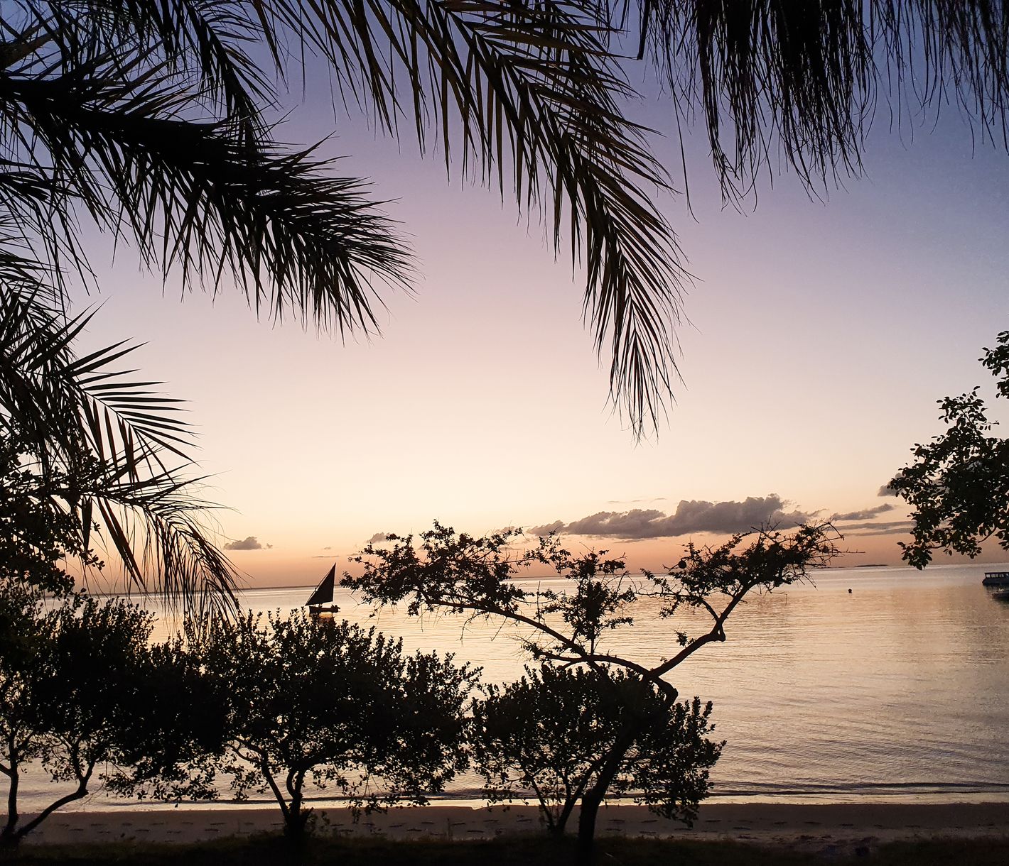 Eine Dhow bei Sonnenuntergang auf einer mosambikanischen Insel