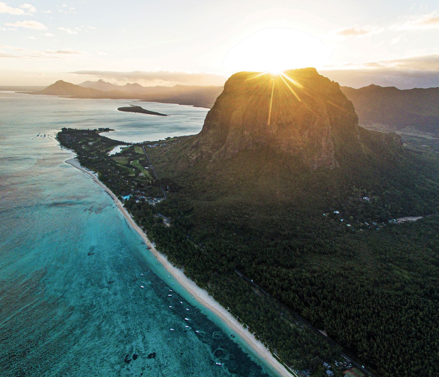 Die Sonne geht hinter dem Morne Brabant unter und taucht die Landschaft in ein goldenes Licht.